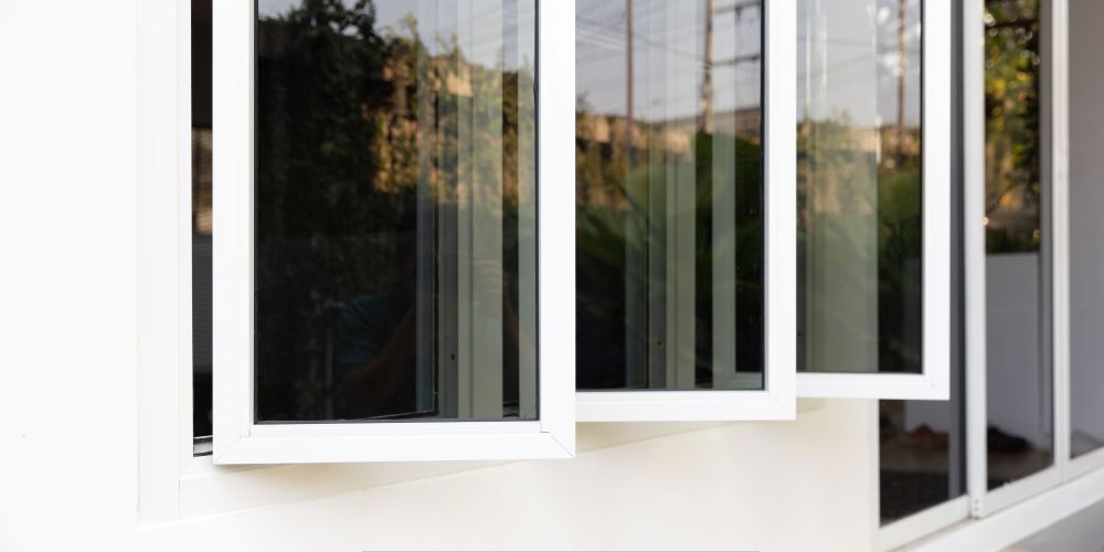 Close-up of modern white replacement windows and doors in Chandler, AZ, featuring energy-efficient casement window design.
